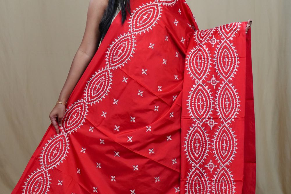 Traditional semi silk saree featuring beautiful hand Kutch work borders and artistic design.
