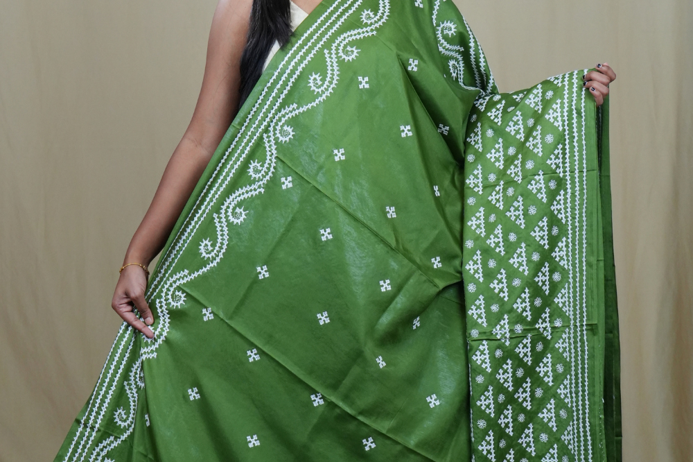 Traditional semi silk saree featuring beautiful hand Kutch work borders and artistic design.
