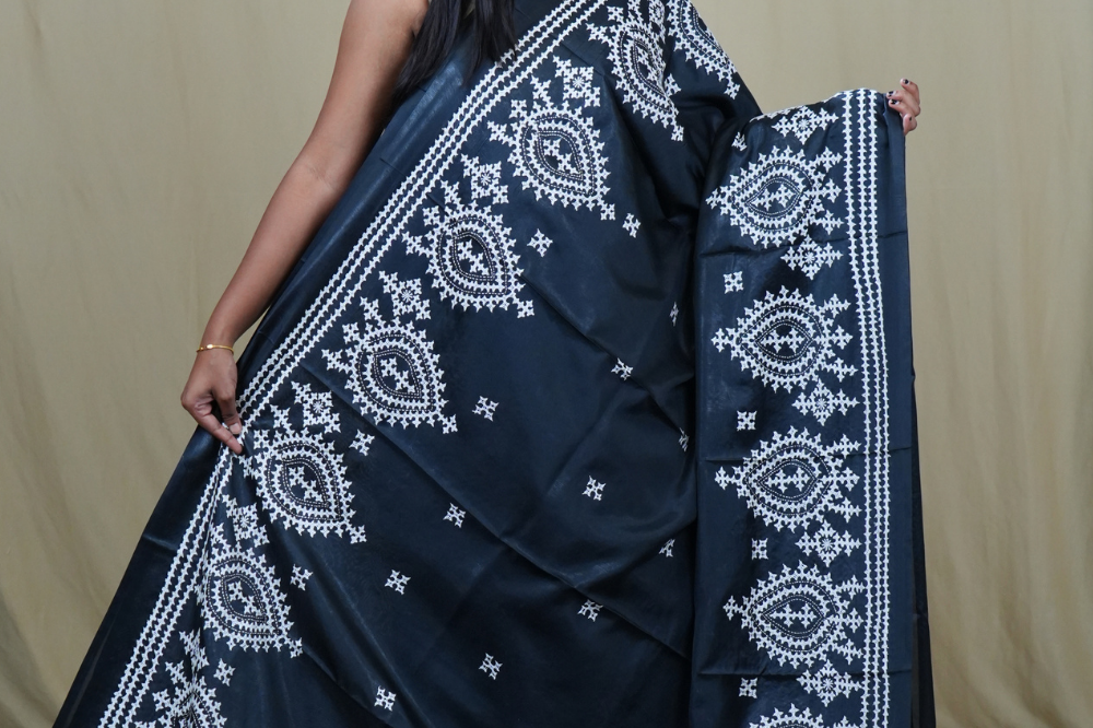 Traditional semi silk saree featuring beautiful hand Kutch work borders and artistic design.
