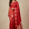 Banarasi Munga Saree with all-over unique zari motifs, zari woven floral bunch borders, rich brocade pallu, and matching running blouse.
