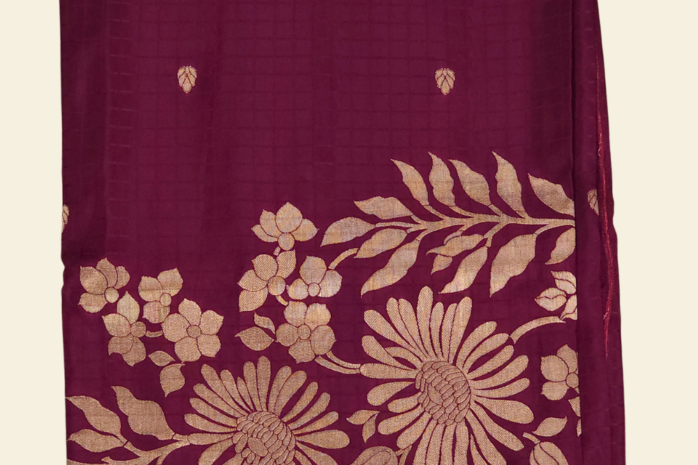 Traditional Banarasi silk saree featuring small zari woven borders and matching blouse with zari motifs.
