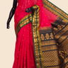 Handloom Gadwal silk cotton saree with all-over zari buttis and rich brocade pallu.
