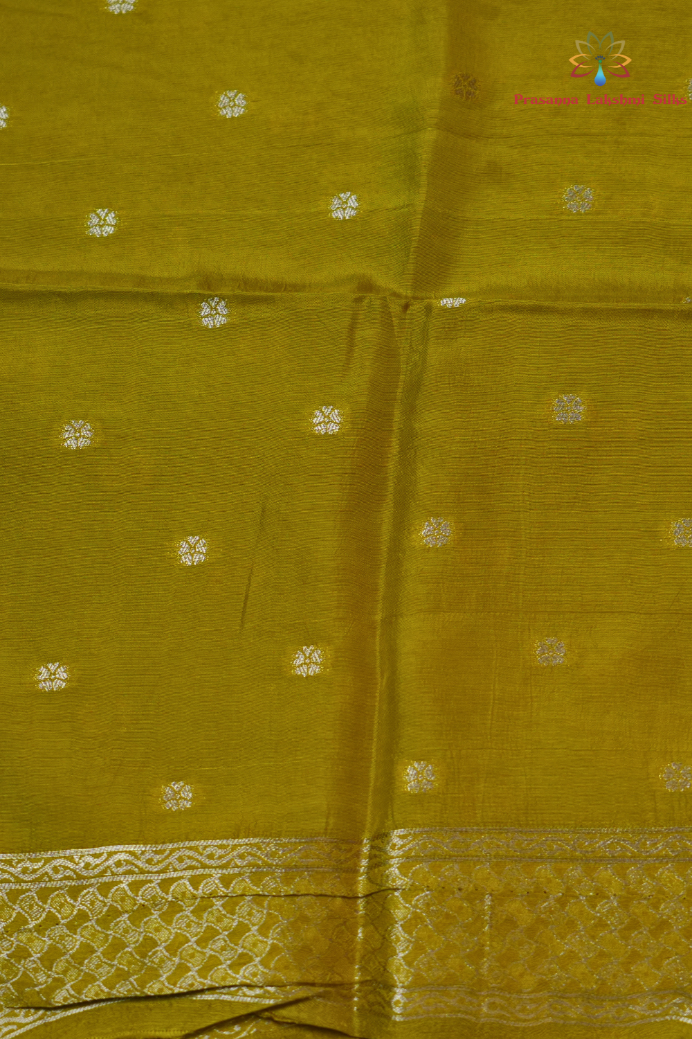 Traditional Banarasi silk saree featuring small zari woven borders and matching blouse with zari motifs.
