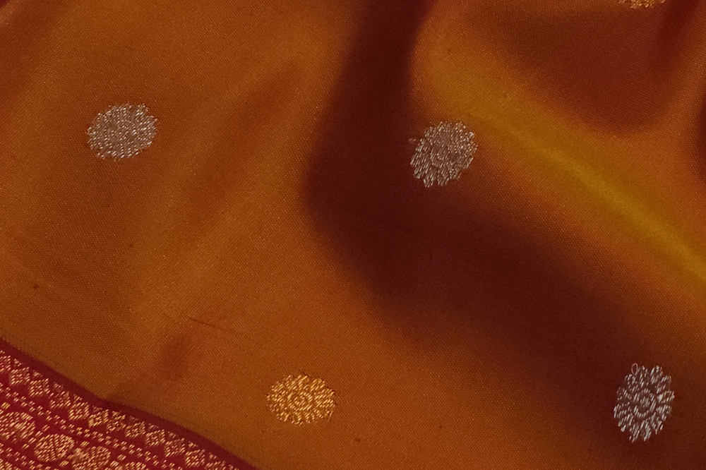 Premium Gadwal Silk Saree with woven zari motifs, luxurious brocade pallu, meenakari turning border, and matching contrast blouse.
