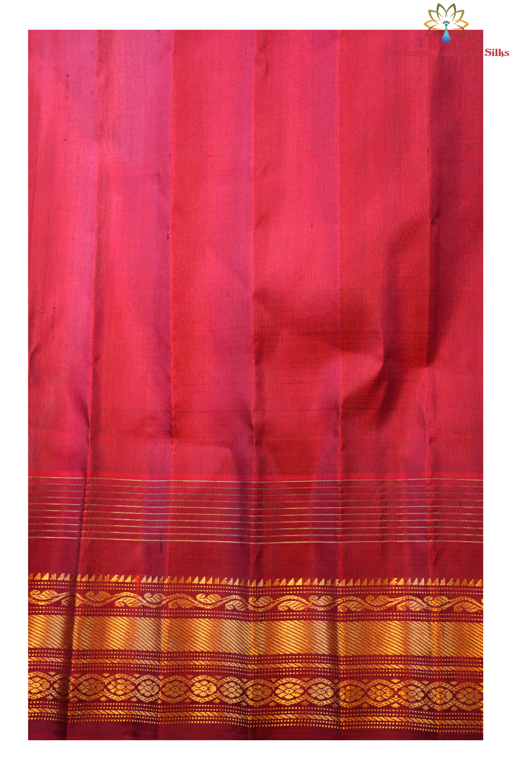 Traditional Gadwal silk saree featuring zari-woven borders and contrast blouse.
