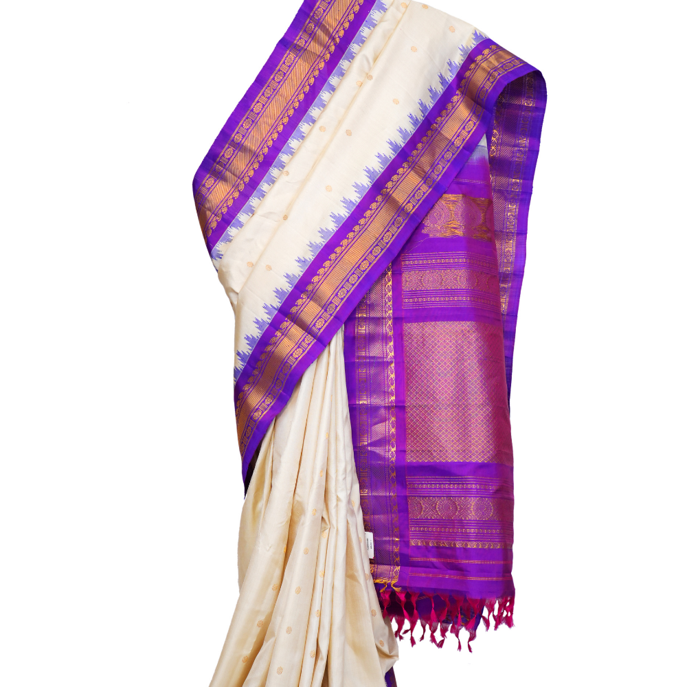 Handloom Gadwal pure silk saree with intricate small zari motifs and rich woven pallu.
