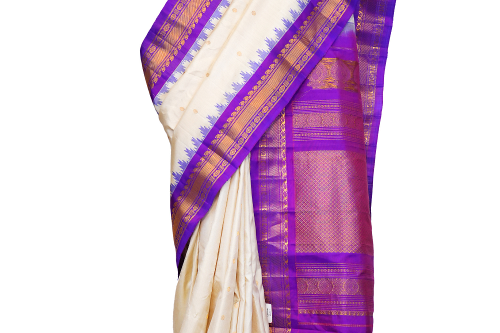 Handloom Gadwal pure silk saree with intricate small zari motifs and rich woven pallu.
