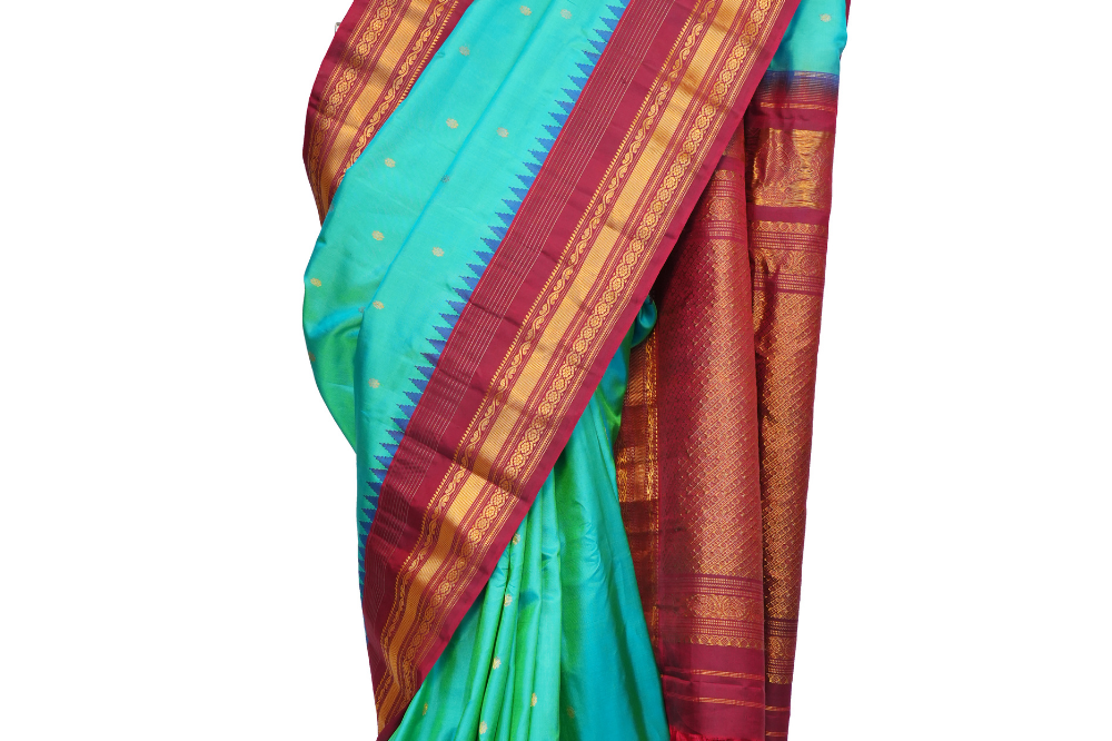 Handloom Gadwal pure silk saree with intricate small zari motifs and rich woven pallu.
