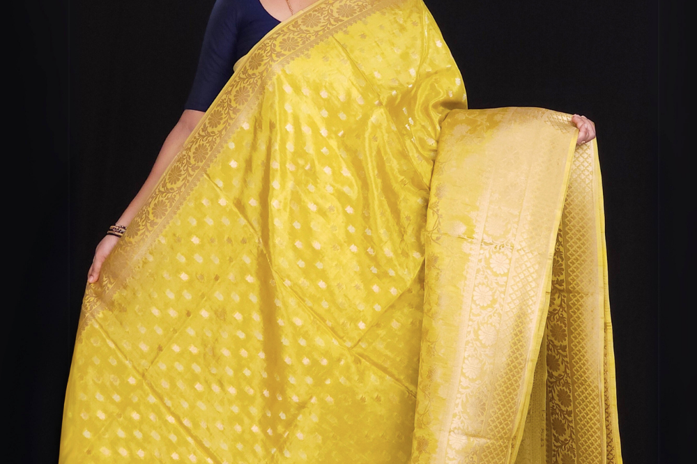  "Mustard Yellow Banaras saree with allover floral motifs  gold Zari  border"