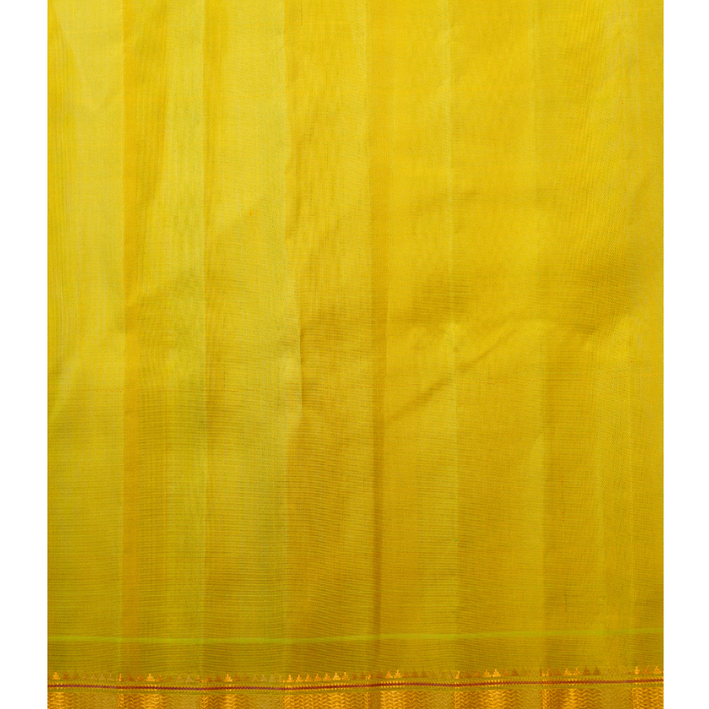Traditional Gadwal silk saree featuring zari-woven borders and contrast blouse.
