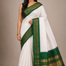 Pure handloom Gadwal cotton saree with traditional zari woven borders and simple zari stripes pallu.
