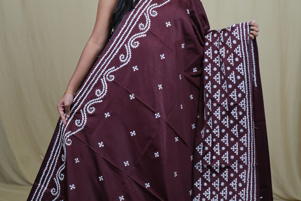 Traditional semi silk saree featuring beautiful hand Kutch work borders and artistic design.
