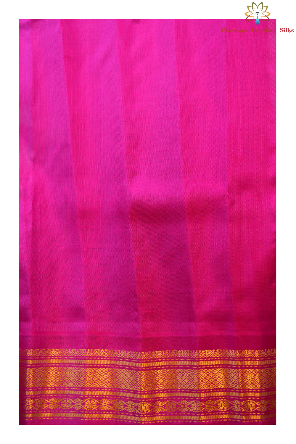 Traditional Gadwal silk saree featuring zari-woven borders and contrast blouse.
