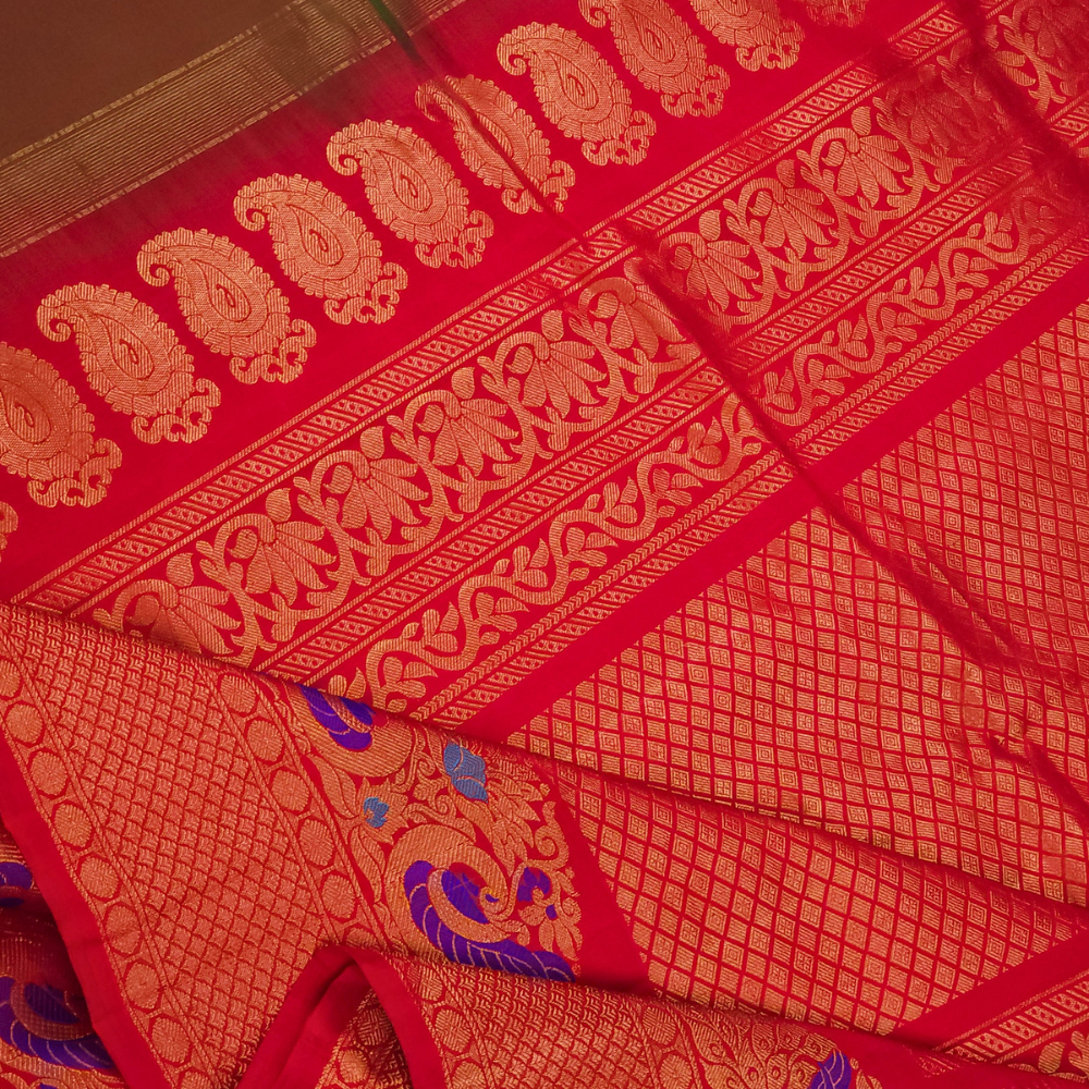 Premium Gadwal Silk Saree with woven zari motifs, luxurious brocade pallu, meenakari turning border, and matching contrast blouse.
