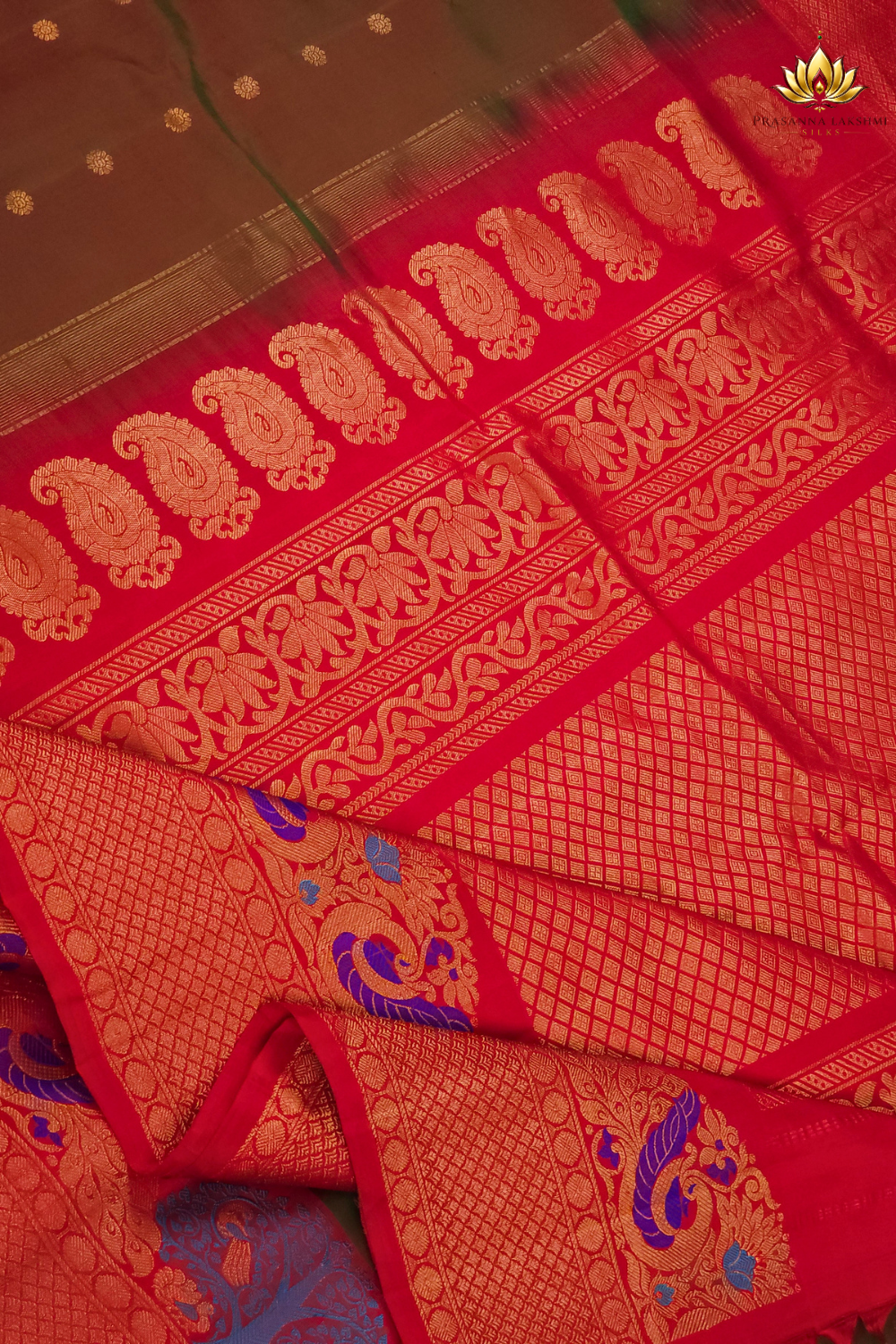 Premium Gadwal Silk Saree with woven zari motifs, luxurious brocade pallu, meenakari turning border, and matching contrast blouse.

