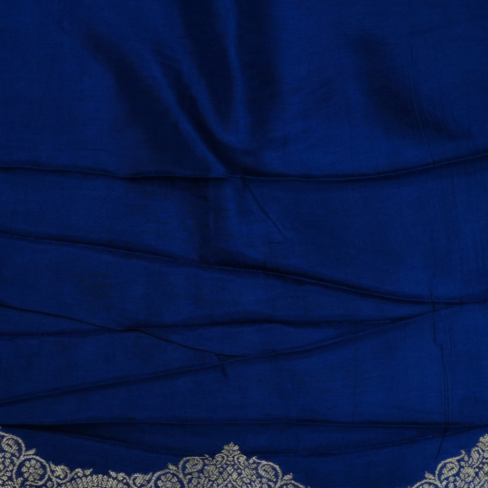 Traditional Banarasi silk saree featuring small zari woven borders and matching blouse with zari motifs.
