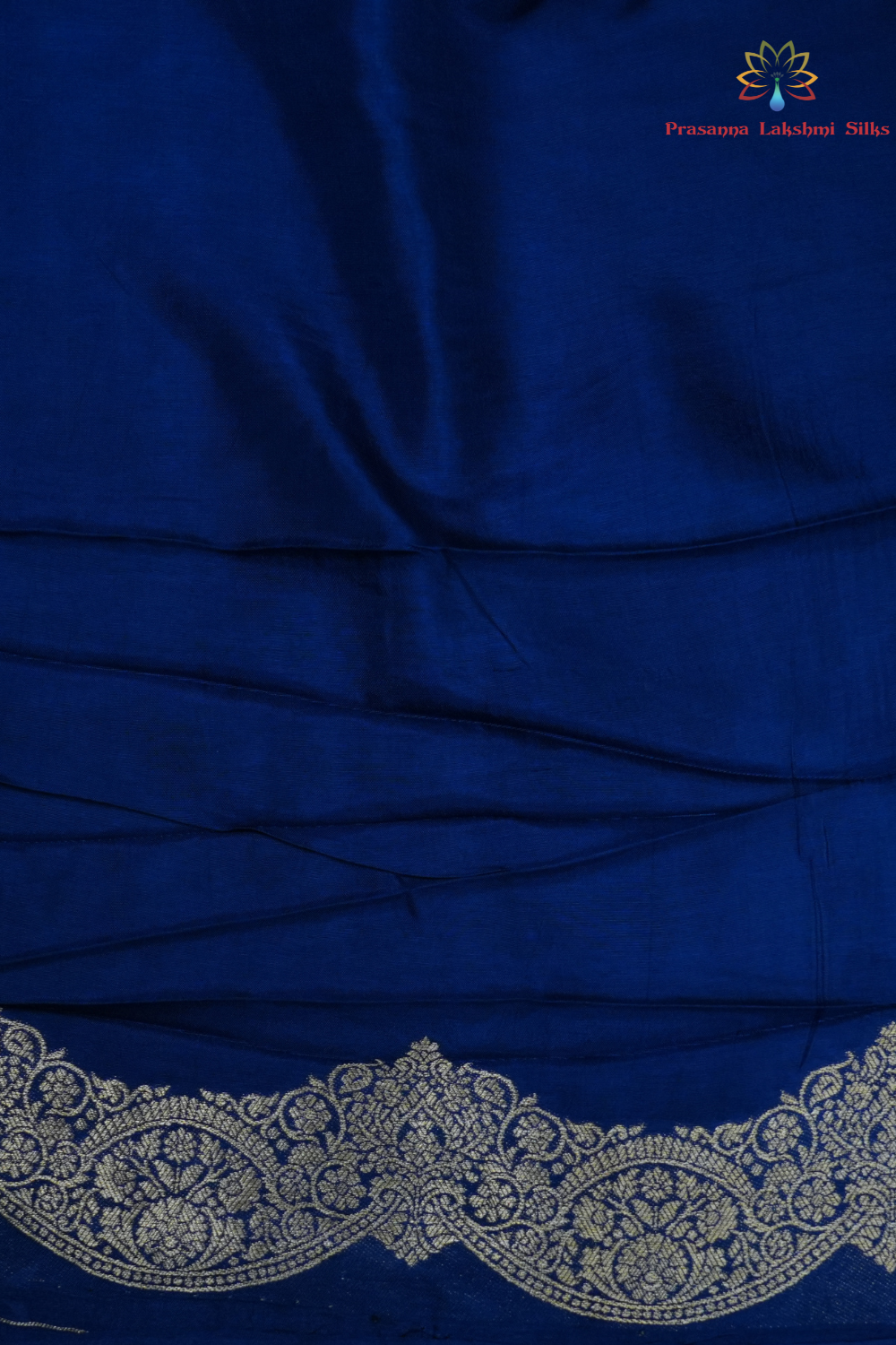 Traditional Banarasi silk saree featuring small zari woven borders and matching blouse with zari motifs.
