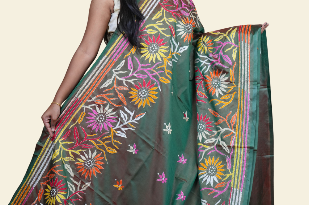 Elegant silk saree featuring Kantha work borders and detailed Kantha pallu design.
