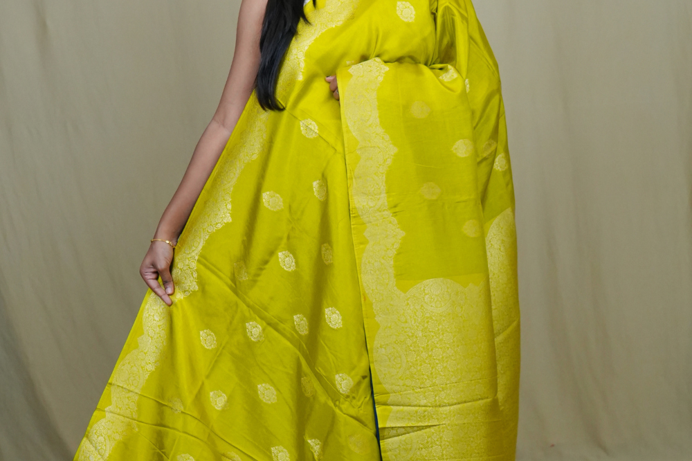Banarasi Munga silk saree with all-over zari woven floral motifs and rich brocade pallu.
