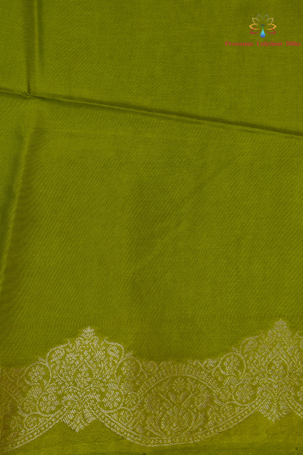 Traditional Banarasi silk saree featuring small zari woven borders and matching blouse with zari motifs.
