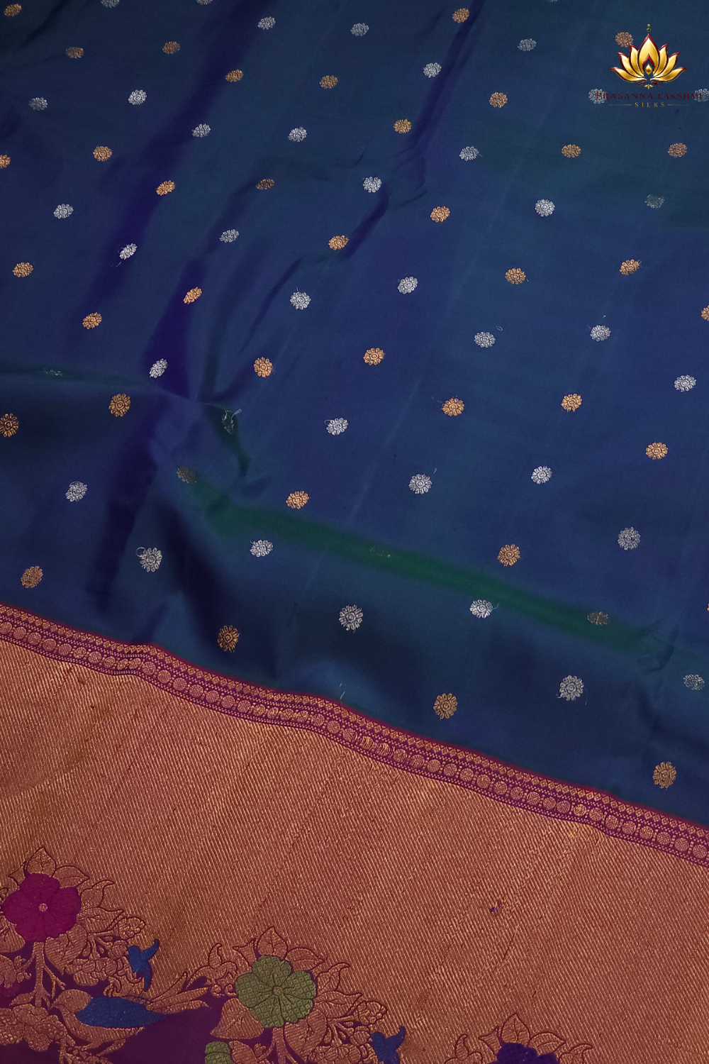 Premium Gadwal Silk Saree with woven zari motifs, luxurious brocade pallu, meenakari turning border, and matching contrast blouse.
