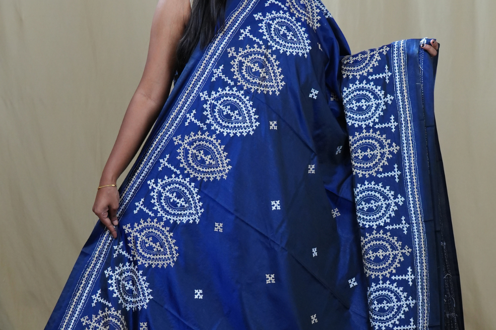 Traditional semi silk saree featuring beautiful hand Kutch work borders and artistic design.
