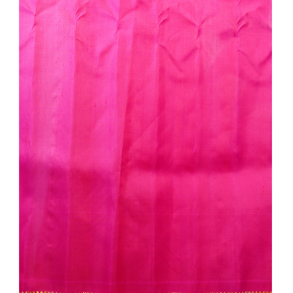 Traditional Gadwal silk saree featuring zari-woven borders and contrast blouse.
