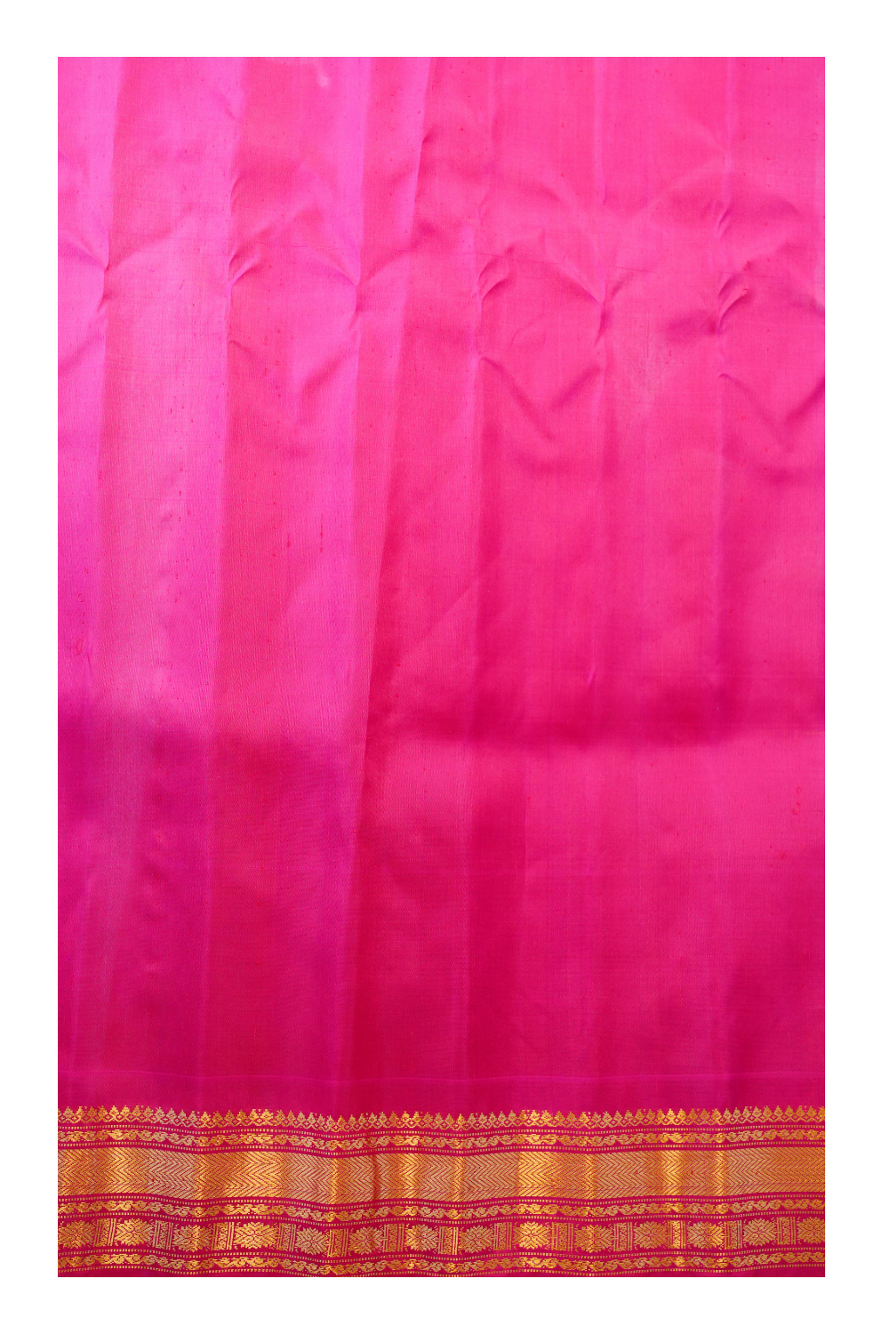 Traditional Gadwal silk saree featuring zari-woven borders and contrast blouse.

