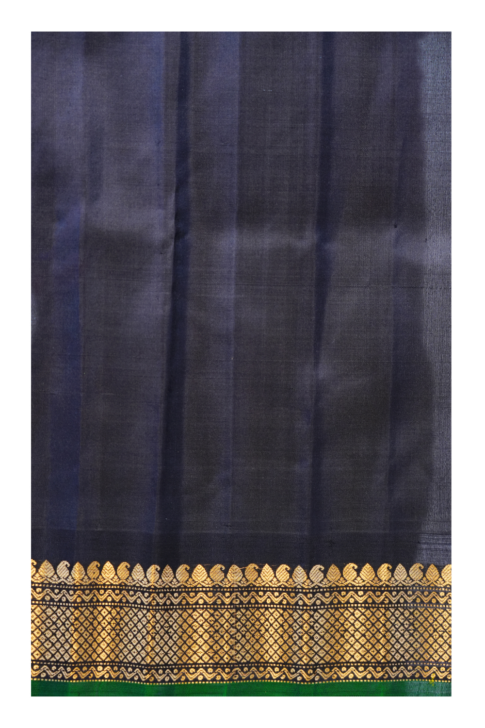 Traditional Gadwal silk saree featuring zari-woven borders and contrast blouse.
