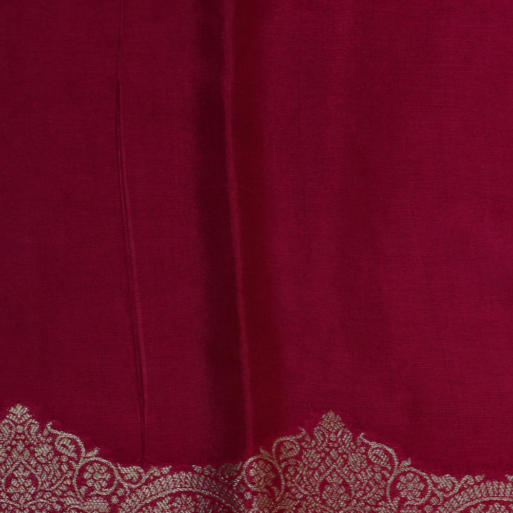 Traditional Banarasi silk saree featuring small zari woven borders and matching blouse with zari motifs.
