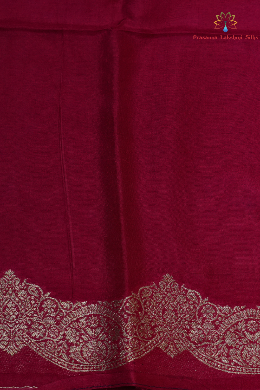 Traditional Banarasi silk saree featuring small zari woven borders and matching blouse with zari motifs.
