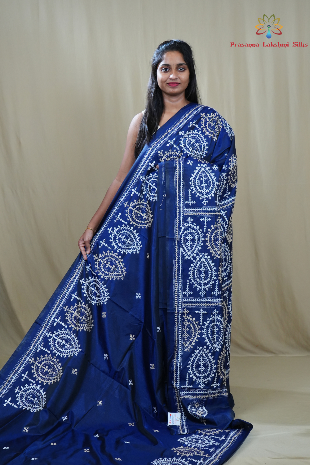 Semi Bangalore Silk Saree with all-over Kutch work motifs and rich embroidered pallu.

