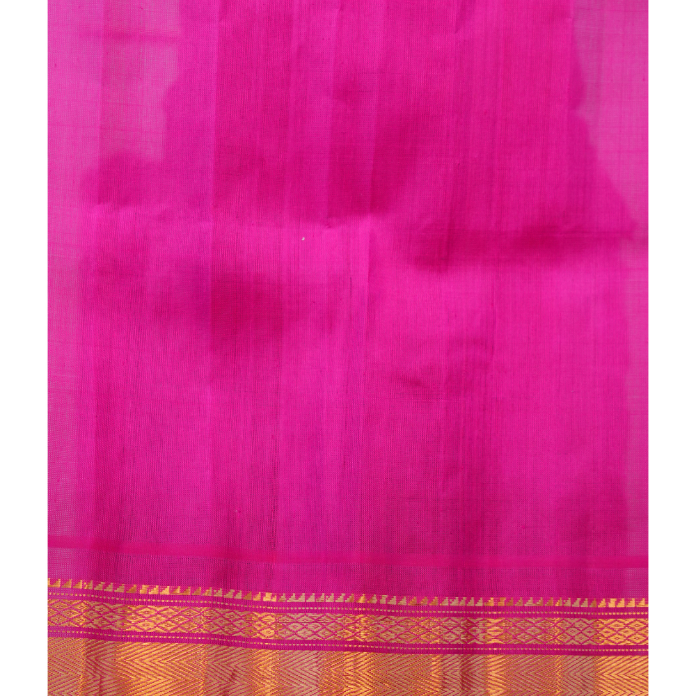 Traditional Gadwal silk saree featuring zari-woven borders and contrast blouse.
