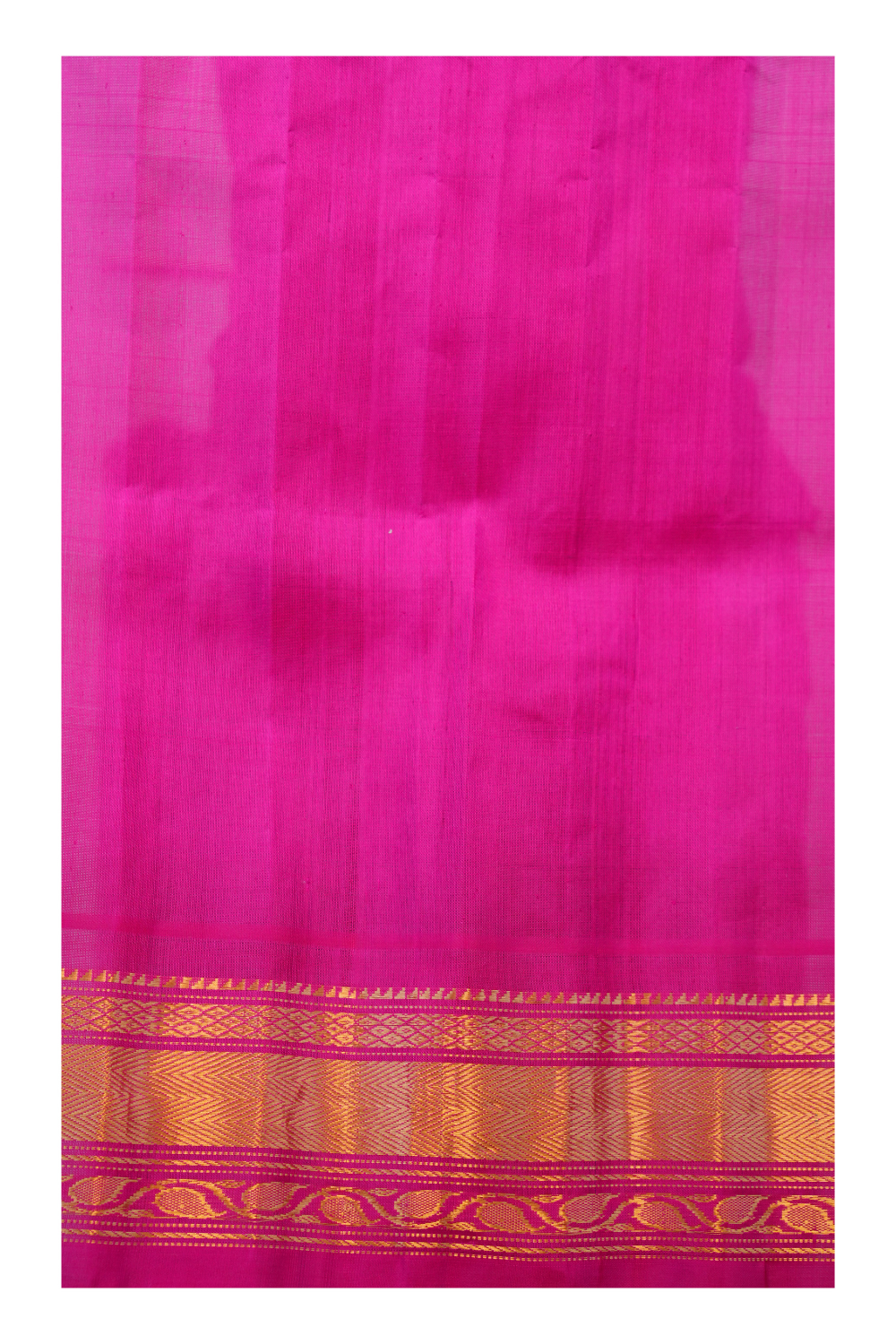 Traditional Gadwal silk saree featuring zari-woven borders and contrast blouse.
