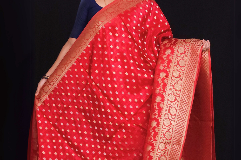  "Red Banaras saree with allover floral motifs  gold Zari  border"