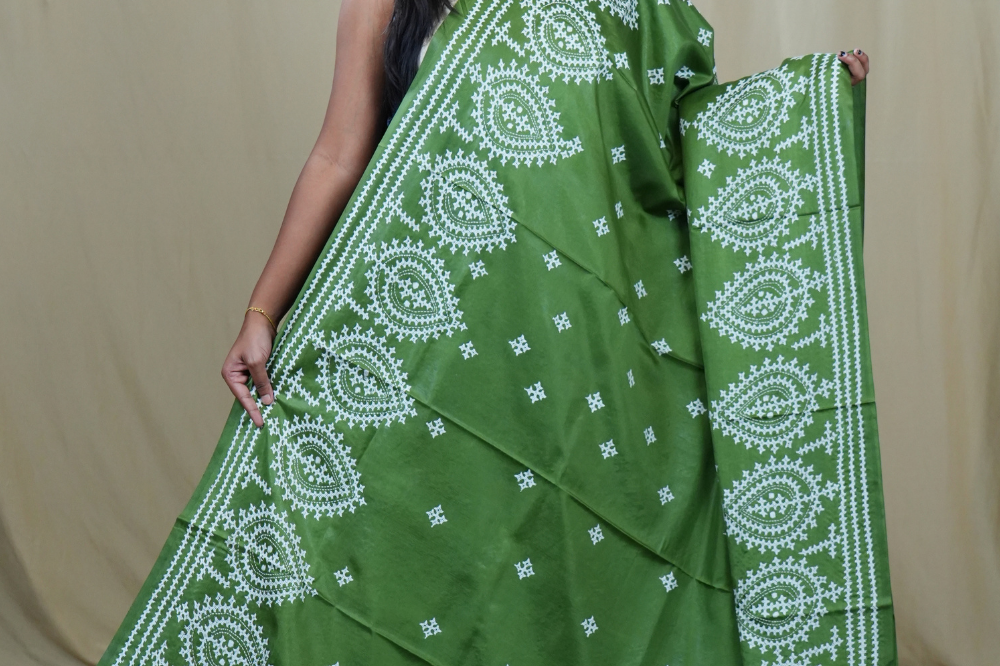 Traditional semi silk saree featuring beautiful hand Kutch work borders and artistic design.

