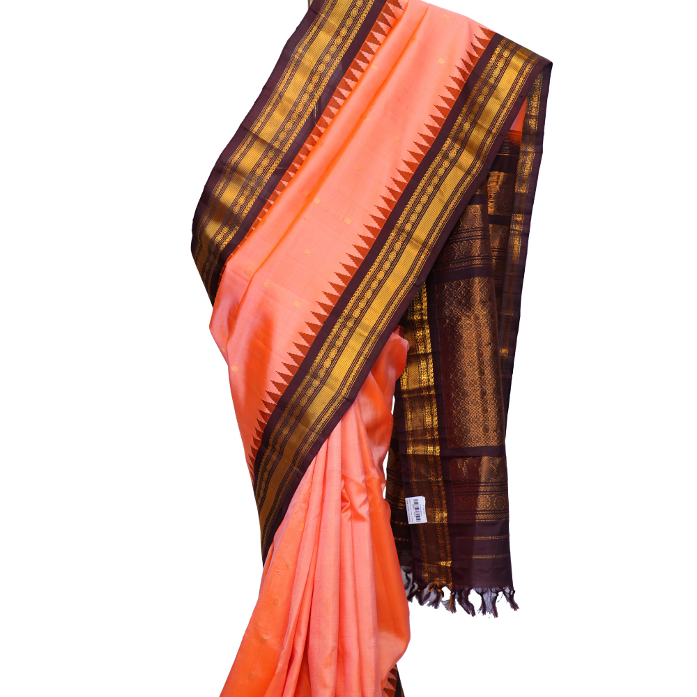 Handloom Gadwal pure silk saree with intricate small zari motifs and rich woven pallu.