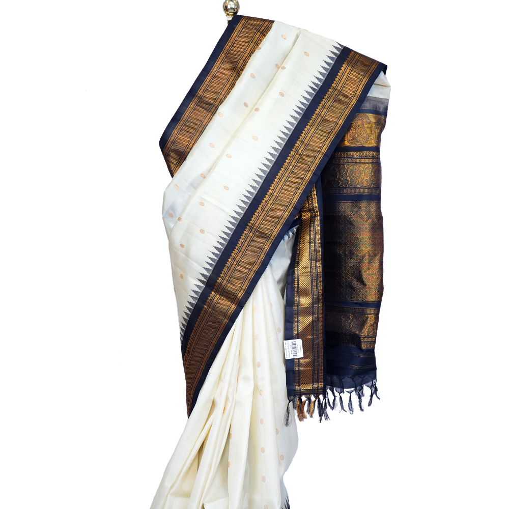 Handloom Gadwal pure silk saree with intricate small zari motifs and rich woven pallu.
