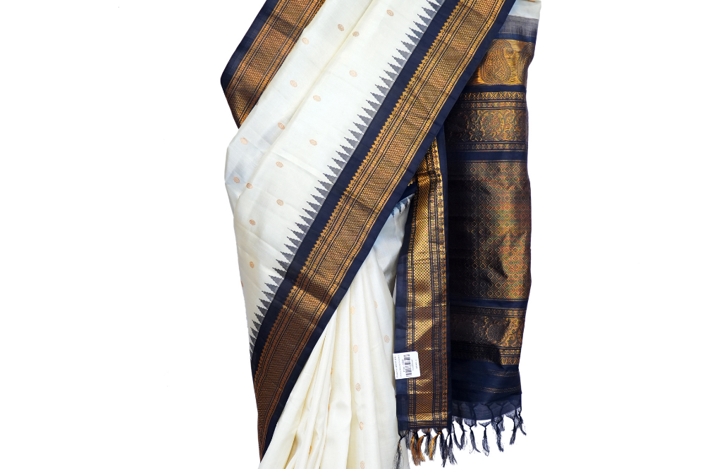 Handloom Gadwal pure silk saree with intricate small zari motifs and rich woven pallu.
