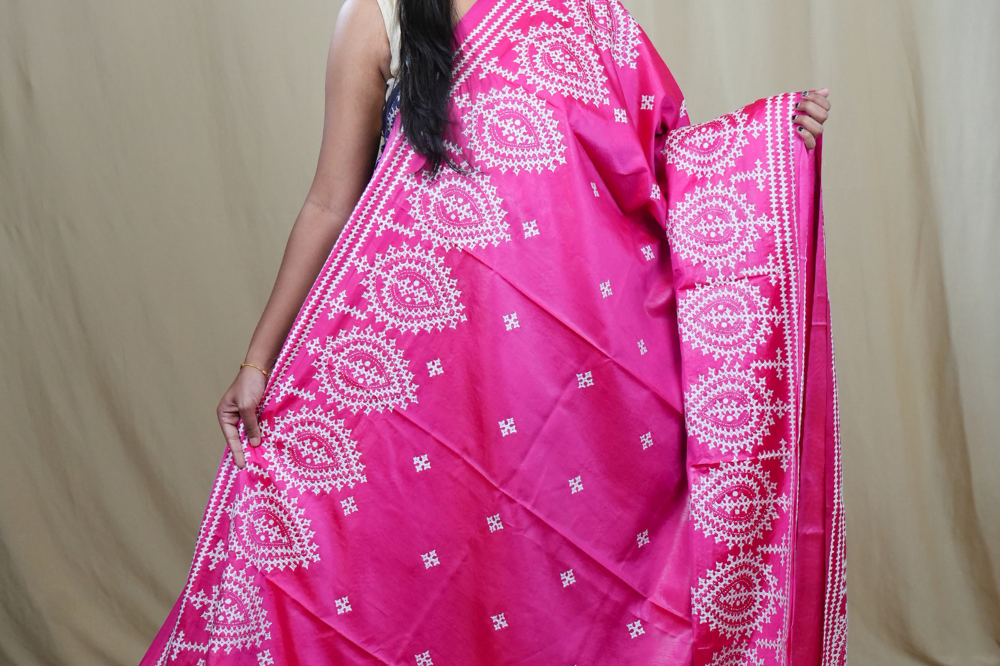 Traditional semi silk saree featuring beautiful hand Kutch work borders and artistic design.
