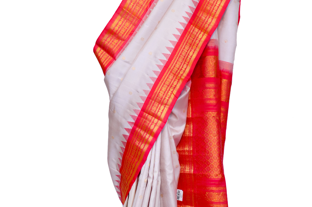 Handloom Gadwal pure silk saree with intricate small zari motifs and rich woven pallu.
