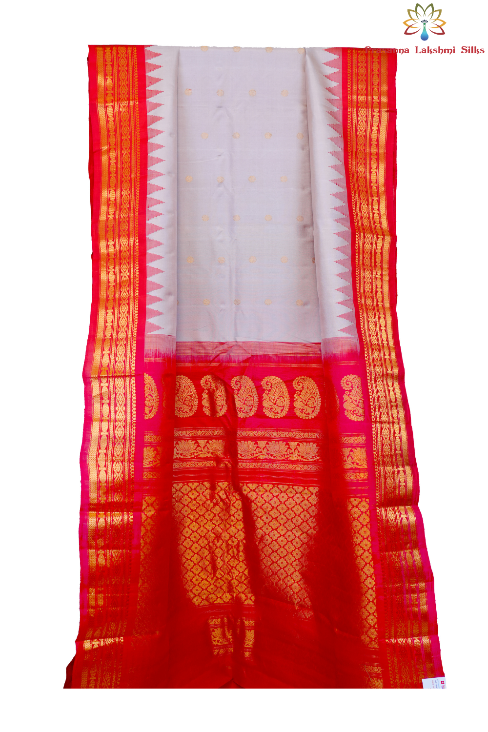 Traditional Gadwal silk saree featuring zari-woven borders and contrast blouse.
