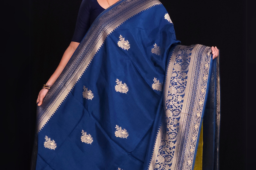 "Prussian Blue Banaras saree with  gold Zari Blue border"

