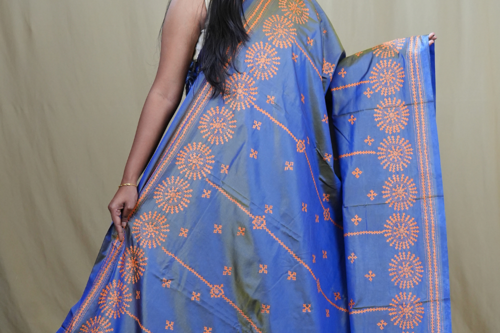 Traditional semi silk saree featuring beautiful hand Kutch work borders and artistic design.
