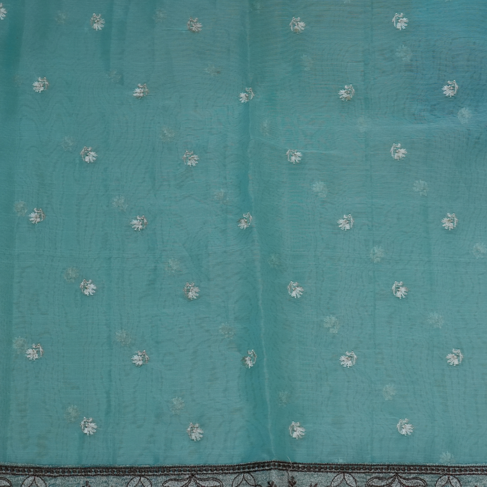 Elegant ethnic organza saree featuring floral pallu design and matching running blouse.

