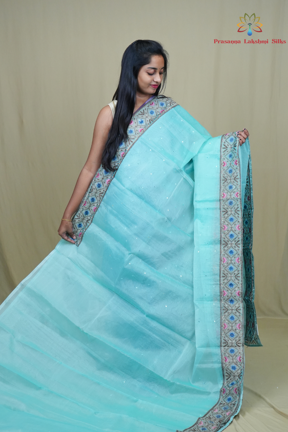 Traditional lightweight Organza Saree suitable for weddings and festive occasions with mirror work.