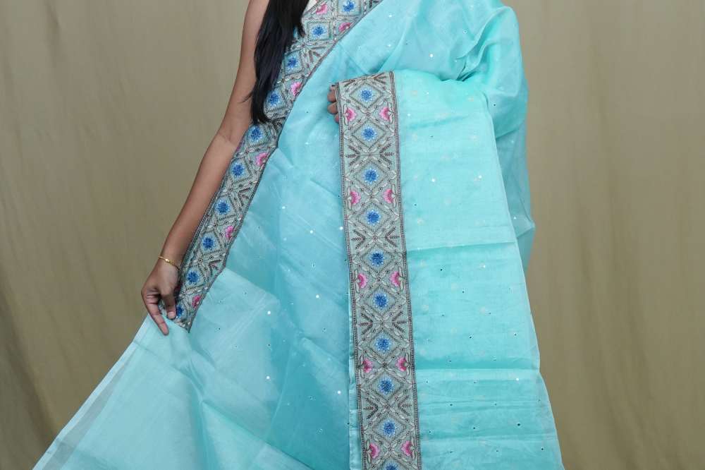 Organza Saree with all-over small mirror work and thread-woven tissue floral borders.
