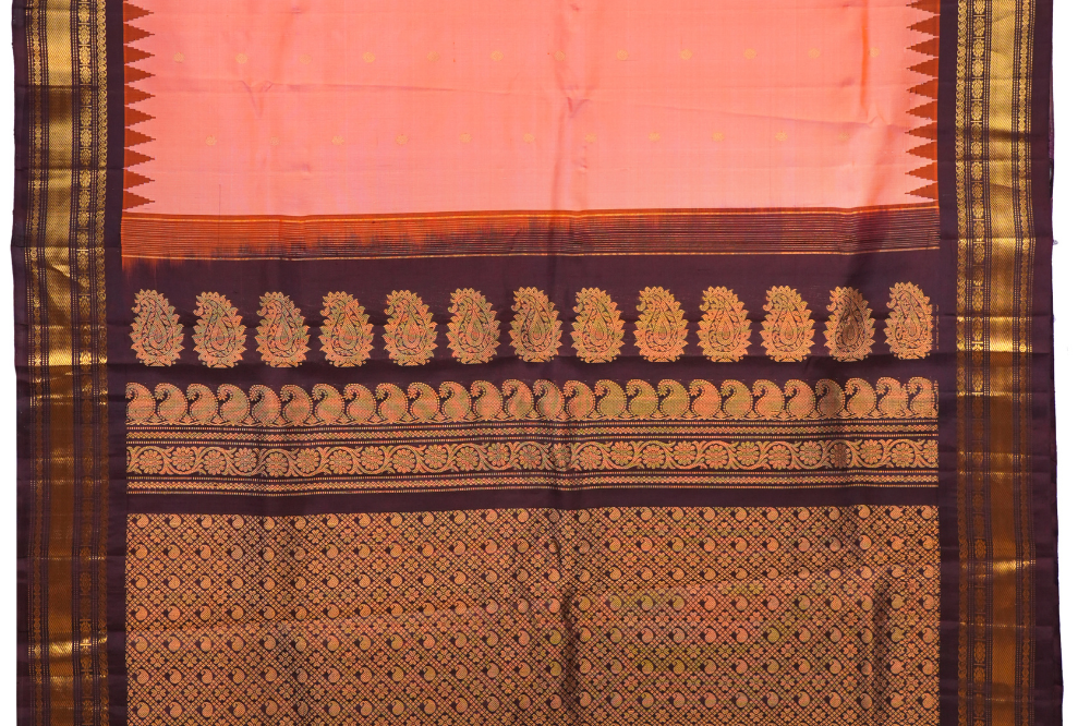 Traditional Gadwal silk saree featuring zari-woven borders and contrast blouse.
