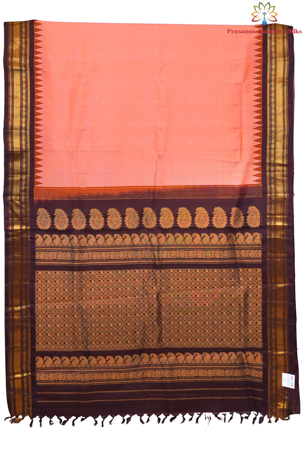 Traditional Gadwal silk saree featuring zari-woven borders and contrast blouse.
