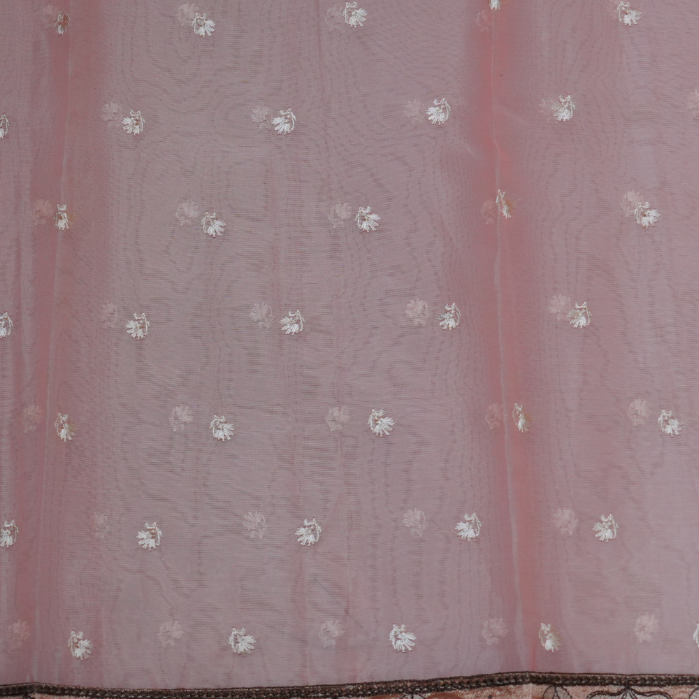 Elegant ethnic organza saree featuring floral pallu design and matching running blouse.
